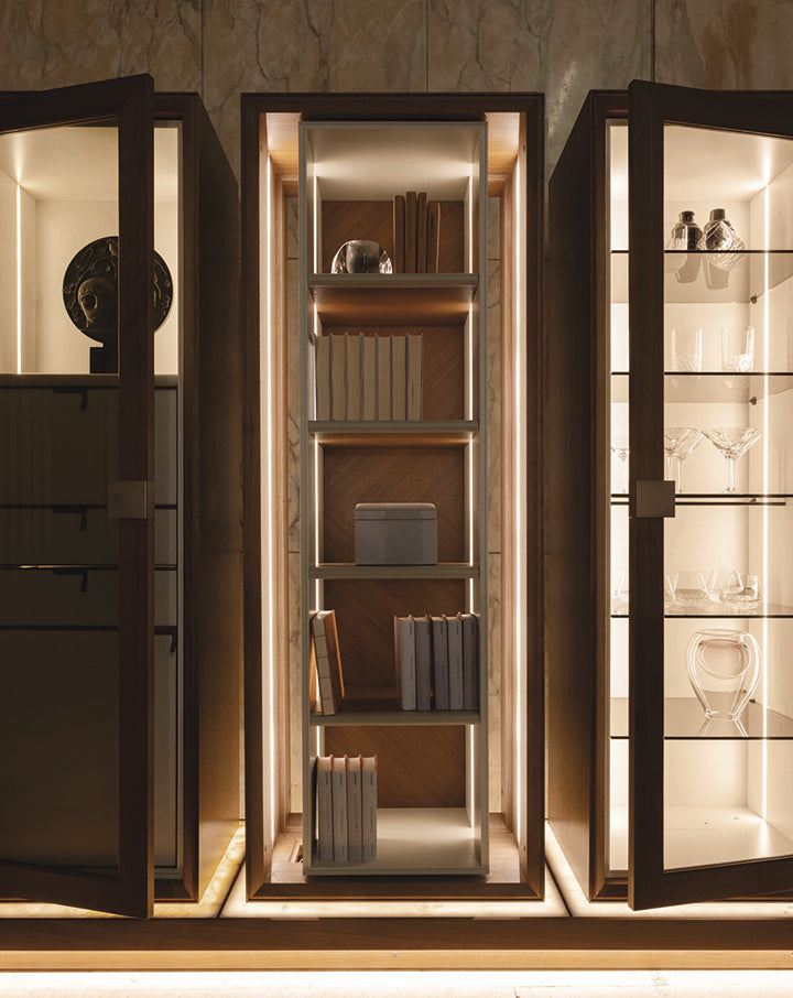 Premium display cabinetry with books and glassware highlighting craftsmanship and material quality.